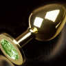 Золотистая анальная пробка с салатовым кристаллом - 9 см.